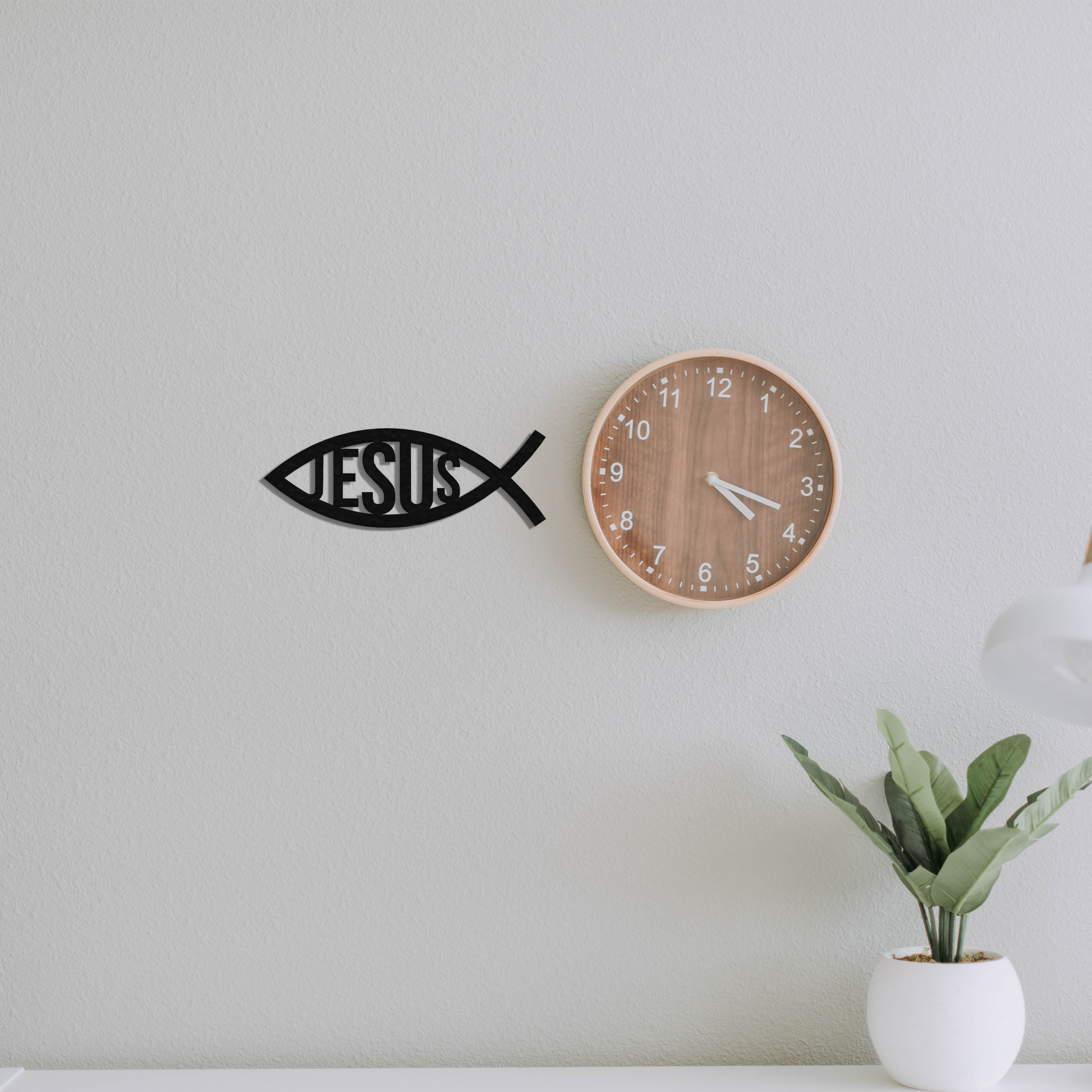 jesus fish metal wall art next to a clock badger steel usa